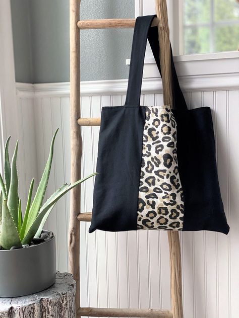 "This is a large tote bag, perfect for carrying everything you need. this bag is quite versatile and would be great as a reusable shopping bag, picnic bag, travel bag, work bag, etc... Bag design is the same on both sides and fully lined in black.  Material: 100% cotton  Size: 17\" width x 15\" length, straps: 2\" wide x 24\" length Do you have a custom design mind? Send a private message to initiate a custom order request! ❤ All items are handcrafted by Desiree Hobson, Owner/Designer/Maker ❤ Fo Animal Print Handbags, Handcrafted Handbags, Personalized Cosmetic Bags, Animal Print Tote Bags, Tote Bags Sewing, Glam Bag, Picnic Bag, Tote Bag Black, Leopard Animal