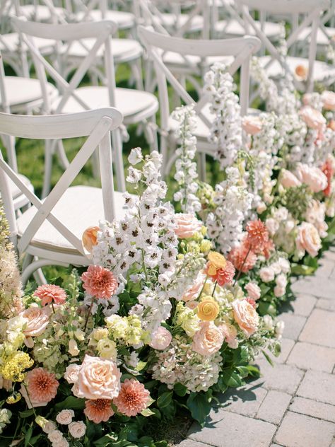 Coral dahlia, pink peach rose, peach foxglove, green hydrangea, white delphinium, eremurus, yellow yarrow, blush spray rose, peach lisianthus ceremony aisle floral hedge Pink Peach White Wedding Decor, Peach Yellow Green Wedding, Peach Foxglove, Wedding Ceremony Aisle Flowers, Floral Hedge, Ceremony Aisle Flowers, Light Yellow Weddings, Ceremony Flowers Aisle, Coral Dahlia