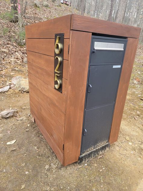 Industrial modern mailbox with wood encasement. Mailbox Package Drop, Mailbox With Package Storage, Mailbox Package Drop Diy, Package Drop Box Ideas, Industrial Mailboxes, Drop Box Ideas, Parcel Drop Box, Diy Carpentry, Mailbox Ideas