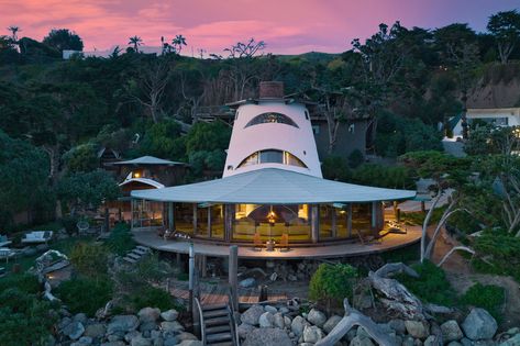 Harry Gesner’s Malibu Sandcastle House Lists for $27.5 Million Sustainable Architecture Design, Wood Plank Ceiling, Taliesin West, Outdoor Cabana, Malibu Home, Plank Ceiling, Porthole Window, Beachfront Home, Reclaimed Brick