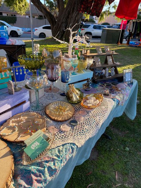 Outdoor vendor jewelry maker table set up in a park at golden hour with antique and vintage decor. Jewelry Tent Booth Ideas, Booth Table Decorations, Jewelry Selling Display Craft Booths, Jewelry Backdrop Display Ideas, Outdoor Jewelry Booth, Market Stall Set Up Earrings, Cute Flea Market Booth Display Ideas, Selling Booth Design Display Ideas, Cute Jewelry Display Ideas