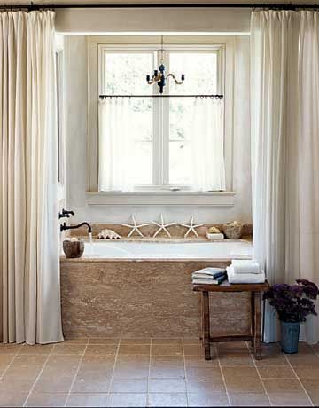 Tumbled-stone tiles on the floor and shower stall envelop this bathroom in soothing natural tones that echo the beach. Starfish and seashells along the edge of the tub simply enhance the earthy theme. Bathroom Windows In Shower, Bathroom Window Curtains, Window In Shower, Double Shower, Garden Tub, Curtain Ideas, Trendy Bathroom, Beach Bathrooms, Bath Room