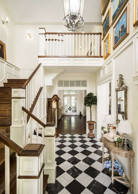 Traditional style entry and staircase in a classic house by The Fox Group. Black and white check floor, white trim, and warm wood on stairs. #traditionaldesign #classicdecor #entry #staircase #housedesign #interiordesigninspiration Entryway Flooring Ideas, The Fox Group, White Foyer, Fox Group, Entryway Tile, Custom Home Plans, Timeless Interiors, Black And White Tiles, Black And White Marble