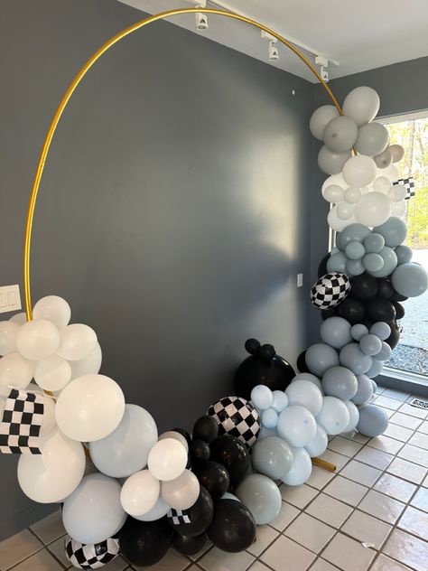 Picture of large gold ring on stand. There are differing shade of blue, black, and white  balloons tied to it.it is against a grey wall. Blue And Black Balloons, Black And White Checkered Baby Shower Ideas, Baby Boy Birthday Decoration, 1 Year Birthday Party Ideas, Arch Light, Boy Birthday Decorations, 2nd Birthday Boys, Blue Birthday Parties, Colorful Birthday Party