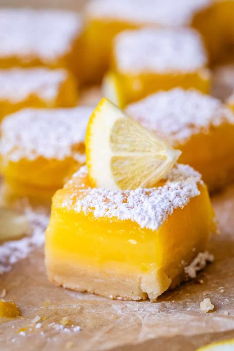 My Favorite Lemon Bars from The Food Charlatan. You don't even KNOW how fast I can finish off a pan of these bad boys; it's embarrassing. There is something incredibly bright and cheerful about lemon squares, from the crumbly-tender buttery shortbread crust, to the thick, pucker-up level of tart lemon flavor in the custard. PERFECTION GUYS. Easy to make, and a crowd favorite for Mother's or Father's Day, baby showers, bridal showers, Easter, Thanksgiving, game day, January blues, you name it! The Food Charlatan, Frozen Lemon, January Blues, Lemon Custard, Lemon Squares, Food Charlatan, Cookie Brownie Bars, Buttery Shortbread, Shortbread Crust