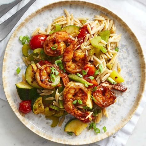 In this healthy BBQ shrimp recipe, shrimp are seasoned with a peppery spice blend and served with zucchini, peppers and whole-grain orzo for a delicious and easy dinner that's ready in just 30 minutes. The shrimp and veggies are cooked in the same skillet, so cleanup is a snap too. Orzo Dinners, Low Cholesterol Meals, Cholesterol Friendly Recipes, Shrimp Bbq Recipes, Shrimp Orzo, Cholesterol Meals, Today Is Monday, Eating Well Recipes, Cholesterol Recipes