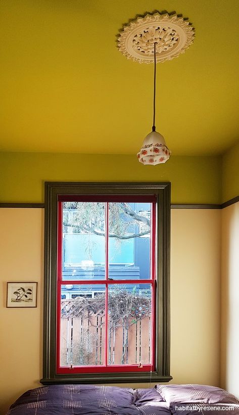 This bedroom is painted in Resene Billy T above the picture rail, with Resene Astra below. The windows are in Resene Shiraz (red) and Resene Vault metallic. #interiordesign #interiorinspiration #interiorideas #bedroominspiration #bedroomideas #bedroomdesign #greenbedroom #greenfeaturewall #colourcombos #colourpalette #resene #greenceiling #ceilinginspiration #ceilingideas