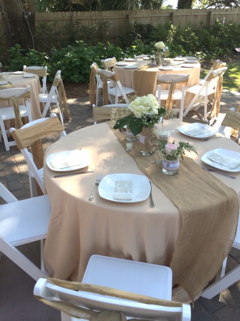 Champagne linens with burlap, white square dishes, hydrangea and blush roses, white resin padded chairs and burlap sashes by The Celebration Place www.thecelebrationplace.com Light Brown Table, Baby Shower Theme Decorations, White Chairs, Grad Party Decorations, Chair Sash, Roses White, Brown Table, Rose Decor, White Chair