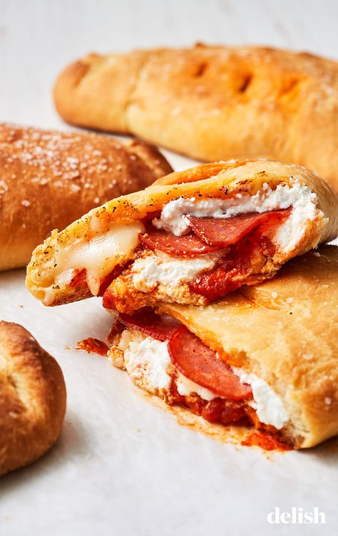 These cheesy, saucy calzones are the ultimate comfort food. Get the recipe at Delish.com. #cheesy #calzone #recipe #easy #withpizzadough #homemade #pepperoni #ricotta Southern Comfort Food Dinners, Italian Calzone, Pizza Dishes, Calzone Recipe, Pizza Pockets, Comfort Food Southern, Comfort Food Recipes Dinners, Comfort Food Recipes, Food Baby