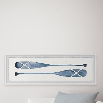 This minimalist print features two oars painted in a dark but diluted watercolor, a perfect accessory for any and all boat enthusiasts. This piece is printed on high-quality archive paper and professionally hand-framed. With wall-mounting hooks included, this artful accent is ready to hang up as soon as it reaches your front door. Size: 10" H x 30" W x 1.5" D | Marmont Hill Paddle Blues Picture Frame Painting Print on Paper Paper in Blue/Brown/Gray, Size 10.0 H x 30.0 W x 1.5 D in | Wayfair | Ho Marmont Hill Art, Paddle Decor, Posters Bedroom, Shoal Bay, Michigan Cottage, Beach Rental, Blue Picture Frames, Coastal Bedrooms, Cottage Bedroom