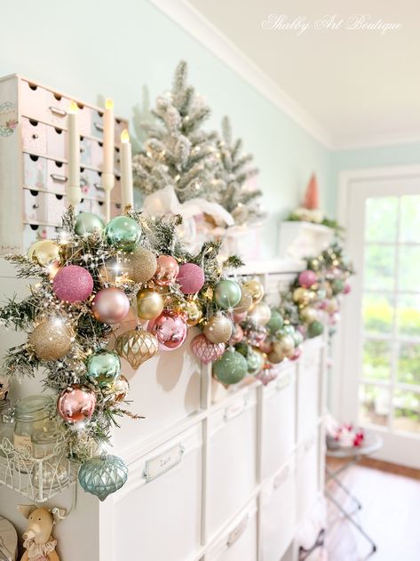 Pink Whimsical Christmas Tree, Craft Room Christmas Tree, Pastel Christmas Mantle, Pink Vintage Christmas Decorations, Pink Christmas Display, Pink And Green Nutcracker, Christmas Decor Ideas Pastel Colors, Pink Christmas Fireplace Decor, Extra Christmas Decor