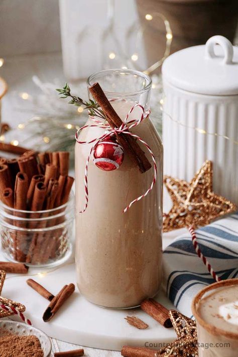 Celebrate the holidays with a festive cinnamon eggnog! This easy spiced eggnog recipe combines creamy eggnog and warming cinnamon for the coziest sip of the season. It's a delicious drink to warm up your festive celebrations. Eggnog is a classic wintertime and holiday drink. It has a rich, creamy texture and is traditionally made with milk, sugar, egg yolks, and sometimes egg whites. This homemade cinnamon eggnog is beautifully thick and creamy and wonderfully spiced. | CountryHillCottage.com Virgin Eggnog Recipe, Alcoholic Eggnog, Dairy Free Egg Nog, Spiced Eggnog, Cozy Winter Recipes, Creamy Eggnog, Cranberry Pie, Homemade Eggnog, Vanilla Fudge