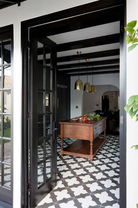 Contemporary Black and White kitchen with quatrefoil tiles feature a set of Stanley 3 Brass Pendants over an antique wood center island. Wood Stain Island, Modern Spanish Style Homes, Modern Spanish Style, Spanish Style Bathrooms, Spanish Style Kitchen, Spanish Style Decor, White Bathrooms, Black Wood Stain, Spanish Interior