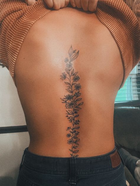 Flower Spine Tattoo Womens Floral Spine Tattoo Black Women, Spine Coverup Tattoos For Women, Wildflower Tattoo On Spine, Back Floral Tattoo Spine, Sun Flower Spine Tattoo, Feminine Spine Tattoos Butterfly, Sick Spine Tattoos, Spine Stencil Tattoo, April Birth Flower Spine Tattoo