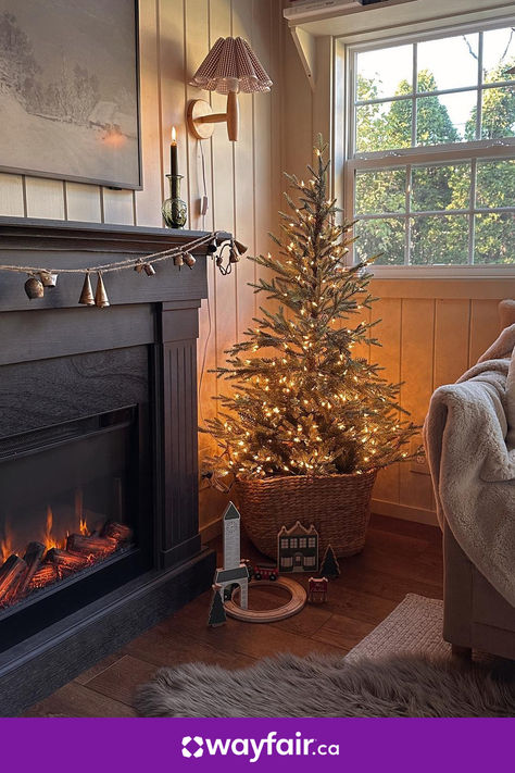 Step up your seasonal style with this holiday-ready living room. A checkered sconce, a toy train set, and wintery wall art will have the whole family feeling festive. Cozy Christmas Decor, Faux Tree, Fur Rug, Rustic Holiday, Beautiful Christmas Trees, Pretty Christmas, Woven Basket, Christmas Tree Themes, Holiday Inspiration