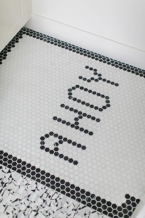 Customize bathroom floors with a word design like this black hex bath tiles spelling "Ahoy". Letterfolk Tile Mat Ideas Bathroom, Penny Tile Writing, Penny Tile Words Floor, Penny Tile With Words, Small Hexagon Tile Bathroom Floor Black And White, Black Clawfoot Tub, Penny Tiles Bathroom, Black Shower Doors, White Laundry Rooms