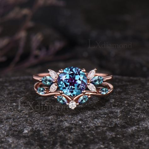 Item description ✦ Handmade, high-quality item! ✦ Material: 925 sterling silver, Solid 10k/14K/18K GOLD (can be made in white/rose/yellow gold) Engagement ring ✦ Center stone: Lab Alexandrite. ✦ Size/Weight: 7mm Round Cut ✦ Side stones: Marquise Cut Lab Alexandrites and Moissanites. Wedding bands ✦ Gemstones: Marquise Cut Lab Alexandrites and Round Cut Moissanites. Any ring size can be made,if the ring size is not in the option list ,contact me. As it is handmade,it needs 3-4 weeks to finish and then be shipped by usps or DHL. Return policy: We offer 30 days return policy. For any reason, if you are not completely satisfied with your order, you may return it for a refund.  Buyer is responsible for the handcraft fee (15%-30% of the total price) and the return shipping cost. Alexandrite And Moonstone Ring, Engagement Rings Alexandrite, Blue Stone Engagement Ring, Engagement Rings Women, Alexandrite Wedding Ring, Delicate Engagement Ring, Jewel Tone Wedding, Future Engagement Rings, Alexandrite Engagement Ring