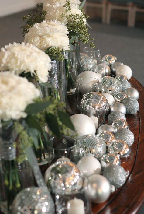 Buy silver Christmas balls on sale to use for winter wedding decorations. Carnations tied with silver ribbon, surround by silver balls and floating candles Silver Christmas Wedding, Christmas Wedding Centerpieces, Christmas Weddings, Winter Wedding Decorations, Christmas Tabletop, Silver Ribbon, Reception Flowers, Christmas Color, Winter Formal