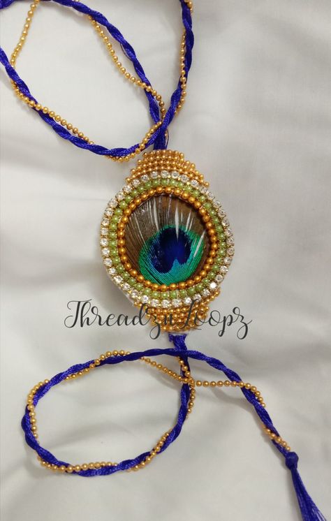 Mayurpankhi Rakhi, handmade with bright stone and pearl chain. Silkthread rakhi for this rakhi 2021. #threadznloopz Krishna Rakhi, Rakhi Making, Radha Painting, Rakhi Design, Gotta Patti, Stick Crafts, Krishna Radha Painting, Krishna Radha, Pearl Chain