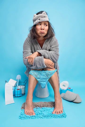 Free Photo | Displeased asian woman feels unhappy and sleepy after early awakening wears sleepmask bathrobe and lace pants pulled down on legs poses in restroom on toilet bowl blue wall suffers from diarrhea Legs Poses, Smiling Person, Concept Photography, Blue Girl, Person Sitting, Lace Pants, Blue Bathroom, Toilet Bowl, Blue Walls