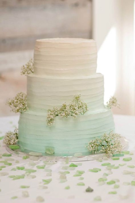 Seaglass colored ombre' cake with scattered seaglass pieces (seaglass theme wedding) Wedding Cake Lake Theme, Sea Glass Wedding Cake, Seaglass Wedding Cake, Seafoam Green Wedding Theme, Seaglass Centerpiece Wedding, Seaglass Wedding Centerpieces, Sea Glass Theme Wedding, Seaglass Green Wedding, Seaglass Centerpiece