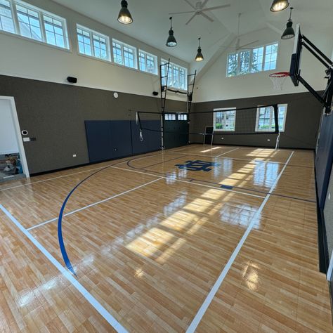 Take a look at this indoor multi-use court in Western Springs! This amazing court features game lines for basketball and pickleball. This Beautiful court was built with our Maple Select surface and features a custom Notre Dame logo, wall pads, a wall mount hoop, and a multi-use net. Contact us today at 630-350-8652 for a free estimate! #Basketball #Pickleball #Volleyball #SportCourt #SportCourtMidwest Notre Dame Logo, Sport Court, Logo Wall, Pickleball, Dream Life, Notre Dame, Volleyball, Springs, Wall Mount