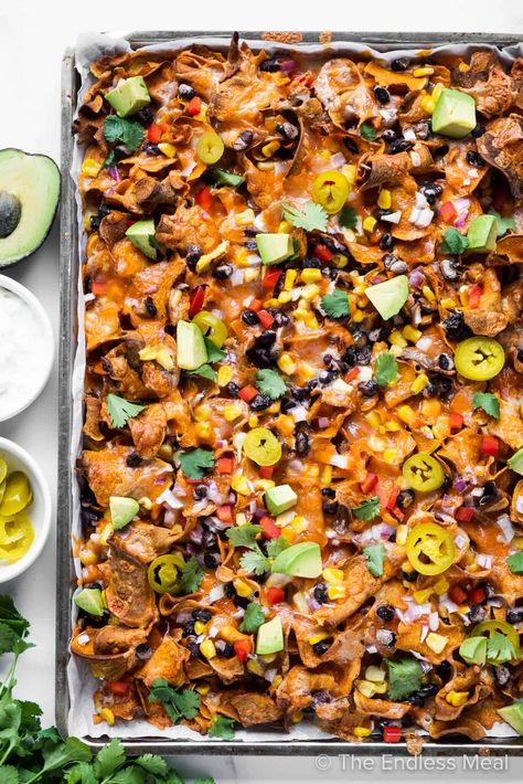 These sweet potato nachos are a delicious, healthier spin on nachos using sweet potatoes instead of corn chips. They're loaded with good for you toppings like black beans, corn, and avocado, then smothered in cheese, and oven-baked to a crisp, easy-to-make meal. . Serve them to a crowd or enjoy them as a quick meal that's ready in under 30 minutes! #theendlessmeal #nachos #mexicanrecipes #sweetpotatoes #loadednachos #superbowl #party #appetizerrecpes #dinnerecipes #sweetpotatonachos Best Sweet Potato Recipes, Paleo Sweet Potato Casserole, Good Sweet Potato Recipe, Sweet Potato Carrot Soup, Bourbon Sweet Potatoes, Smashed Sweet Potatoes, Sweet Potato Toppings, Best Sweet Potato, 30 Minute Meals Healthy