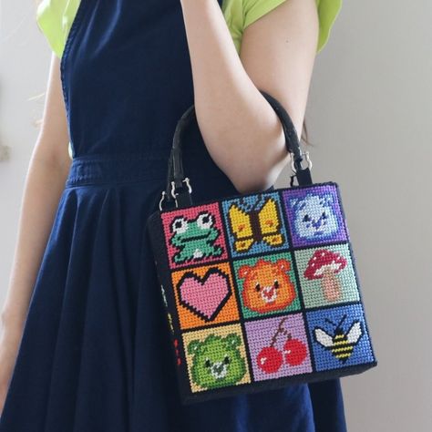 A rainbow square bag with a menagerie of care bears, bugs, rainbows, and flowers Plastic Canvas Pixel Art, Cross Stitch Bag, Stitch Bag, Kawaii Cross Stitch, Canvas Bag Diy, Unique Cross Stitch, Jewels Diy, Cross Stitch Tutorial, Kawaii Bag