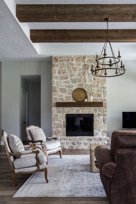 Living room with stone fireplace and rich dark wood beams by Moore House Interiors Rustic Stone Fireplace, Houston Homes, Stone Walls Interior, Family Room Inspiration, Lamps Design, Moore House, Modern Rustic Living Room, Rustic Fireplaces, Warm Decor