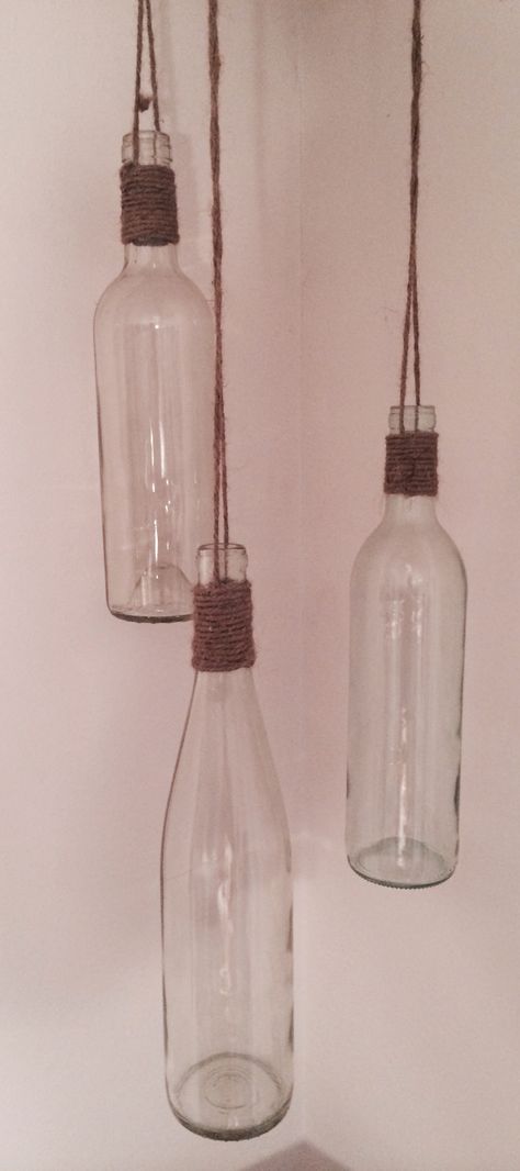 Wine Bottle Twine Crafts, Hanging Wine Bottles, How To Hang Wine Bottles, Hanging Bottle Lights, Hanging Bottles Decoration, Hanging Jars With Twine, Glass Bottle Hanging Ideas, Empty Bottle Ideas Decor, Glass Bottles Hanging Decor