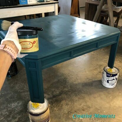 This square light oak coffee table is no longer blah and boring.. it is now boho beautiful with paint. Let me share how I achieved this.Pop over to my blog for more free home decor and furniture tutorials. Clean project    Step 1 is to always clean your piece really well after sanding any loose finish. Paint the table    I brushed on Dixie Belle antebellum blue paint over all surfaces. Add another color    Next was Dixie Belle peacock blue paint randomly brushed all over and blended in… How To Paint A Coffee Table, Colorful Coffee Tables, Boho Coffee Table Diy, Coffee Table Color Ideas, Painting Coffee Table Ideas, Colored Coffee Table, Coffee Table Makeover Diy, Paint Coffee Table, Peacock Blue Paint