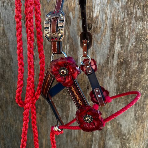 Lariat & Leather Combo Halter is a useful training tool and fashion statement. The leather is two tone with fox tail design. It is accented with Copper Ruby/Jet/Champagne crystal conchos/buckles and leather gardenias. Red lariat noseband with 10' matching nylon lead. Adjustable Crown measures 11" to 19" from buckle to buckle. Overall cheek to cheek sizing is 33” at the shortest setting and 41” at the longest setting. Rope noseband is overall 27” around, and the knots can be adjusted up or down. Red Tack Sets, Western Riding Tack, Barrel Racing Tack Rodeo, Bling Horse Tack, Copper Fashion, Homesteading Animals, Trick Riding, Horse Halters, Barrel Racing Tack