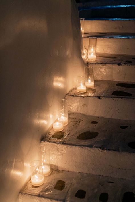 The traditional Cycladic whitewashed stairs of Remezzo Mykonos were decorated with glass cylinder candles | Mykonos Wedding Planner & Designer: @mitheoevents Photo: @sotiristsakanikas Venue: @remezzomykonos | #mitheoevents #weddingplannergreece #mykonosweddingplanner #mykonoseventplanner #mykonosevent #welcomedinner #nauticaldinner #seasidedinner #birthdayevent #remezzomykonos #greekisland #eventstyling #eventdecor #stairs #candles #candledecor Staircase With Candles, Candle Stairs, Seaside Dinner, Erin Morgenstern, Mykonos Wedding, Welcome Dinner, Cylinder Candles, Night Bar, Dinner Table Setting