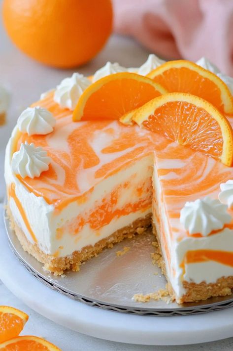 Soft, rich, and oh-so-fruity, this no-bake orange creamsicle cheesecake is an irresistible summer dessert that tastes just like the classic frozen treat. No Bake Creamsicle Cheesecake, Orange Pie No Bake, Orange Dreamsicle Cheesecake, No Bake Orange Creamsicle Cheesecake, No Bake Cookie Cake Recipe, Healthy Orange Cake, No Bake Birthday Cake, Orange Creamsicle Cheesecake Recipe, Cheesecake Treats