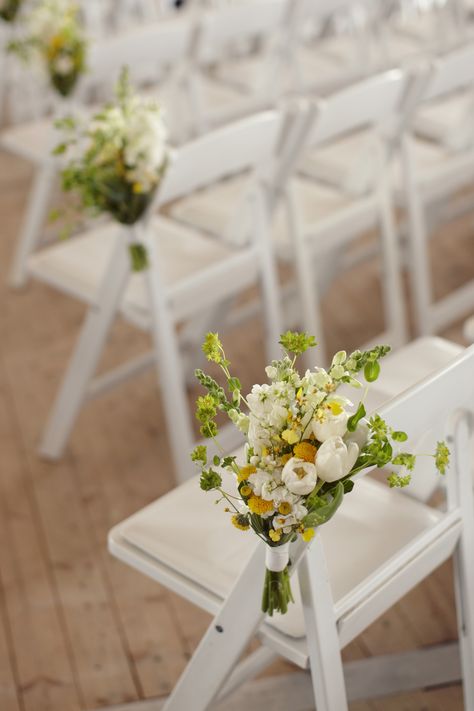 Spring floral arrangements on white resin folding chairs. #yyceventrentals www.greateventsrentals.com Chairs Wedding Ceremony, Wedding Ceremony Chairs, Wildflower Bouquets, Chairs Wedding, White Folding Chairs, Rustic Wedding Ceremony, Ceremony Chairs, Aisle Flowers, Spring Floral Arrangements