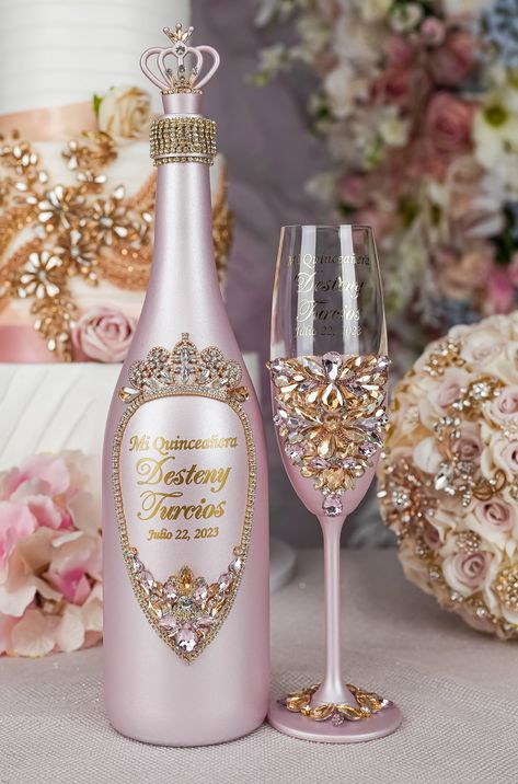 Make Your Quinceañera Party unique with light pink with gold jewels Champagne Bottle! Ready to Fill with Your Favorite Bubbles. This sleek and elegant botella is personalizable to make your Quince party truly memorable.Raise a toast to a memorable Quinceañera with this champagne botella!Set includes: bottle (empty).All the items are hand-made.Can be personalized with name and date of your celebration.We can decorate this set with any color or text you want. Sleeping Beauty Quinceanera Theme, Pink And Gold Quinceanera, Pink Quince Theme, Pink And Gold Quince, Gold Champagne Bottle, Rose Gold Quince, Money Card Box, Rose Gold Quinceanera, Quinceanera Pink