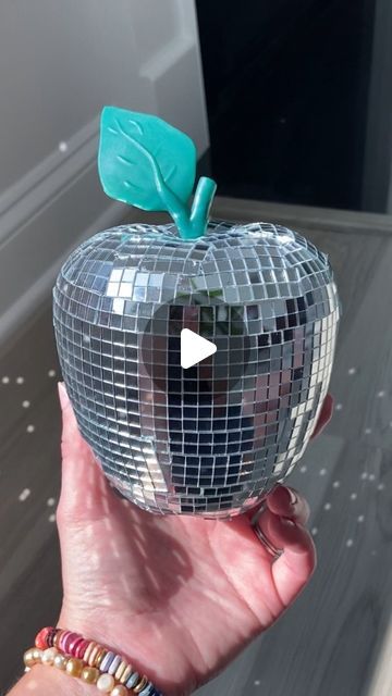 Katie Hovell on Instagram: "Oh hello, Disco Apple 🪩🍎✨  This DIY was surprisingly easy - just grab a plastic apple, some stick-on mirror tiles, and go for it!  Tips that I learned along the way: 🪩 I wish I had painted the apple silver before starting - it would camouflage the cracks in between tiles better! 🪩 Next time, I would try covering vertical sections instead of horizontal sections 🪩 I started out by using a blade to cut between sections of mirror tiles, and by the end I was just pulling apart the sections 🤷‍♀️ Don’t over-complicate it!  I can’t wait to bring this cutie to our classroom! Tag a teacher or friend who would love this Back-to-School disco apple!!! 🪩🍎  #discoballdecor #disco #discoparty #diydecor #classroominspo #diycrafts #classroomdecor #classroominspiration #di Disco Ball Mirror Diy, Disco Ball Tiles Diy, Disco Tiles Diy, Disco Mirror Tiles Diy, Disco Tile Diy, Diy Tile Mirror, Disco Mirror Frame, Stick On Mirror, School Disco