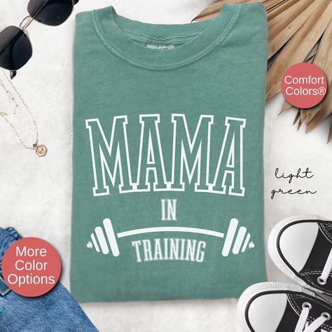 Stay active and celebrate your journey to motherhood with our "Mama In Training" Pregnancy Gym Workout Shirt! Perfect for expecting moms who love fitness and want to share their exciting news, this tee combines comfort, style, and a playful pregnancy reveal all in one. Made from soft, high-quality fabric, this unisex maternity shirt is ideal for workouts, yoga sessions, or just showing off your active mama-to-be vibe. Whether you're hitting the gym, going for a walk, or surprising family and fri Pregnancy Gym Workout, Maternity Workout, Workouts Yoga, Mom Activities, Gym Buddy, Gym Tees, Pregnancy Announcement Shirt, Maternity Shirt, Pregnancy Tshirts