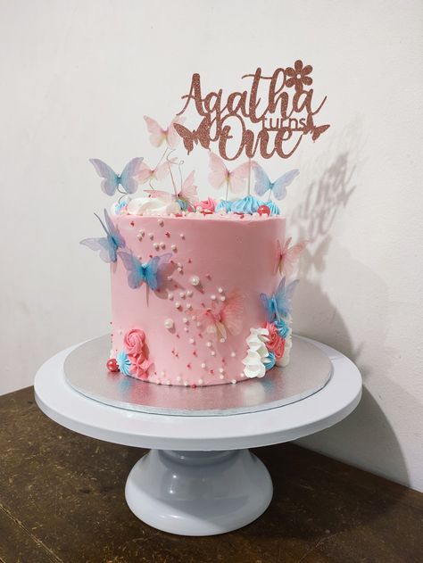 Pastel pink and blue butterfly cake with some dainty florals Blue Butterfly Cake, Pink And Blue Butterfly, Butterfly Cake, Like A Butterfly, Butterfly Cakes, Blue Butterfly, A Butterfly, Pastel Pink, The Wind