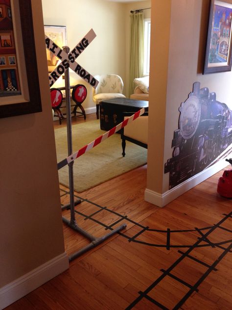 Tape train tracks on the floor, homemade train gate (pvc covered with duck tape, touch lights painted red) Diy Train Tracks On Floor, Train Theme Classroom, Touch Lights, Holiday Living Room Decor, Choir Room, Holiday Living Room, Floor Tape, Transportation Birthday, Vbs 2023