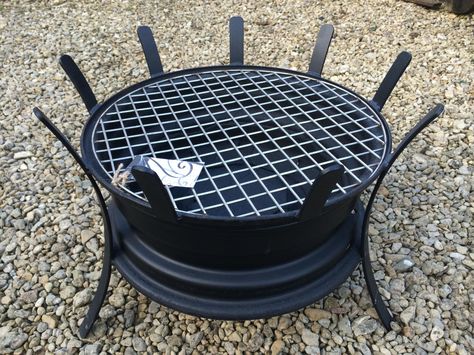 A quirky designed BBQ made from a recycled car steel wheel. The grill is made of stainless steel, so no problem with this going rusty. The grill can be removed after cooking and the BBQ can then be… Diy Car Projects, Cave Decorations, Rim Fire Pit, Modern Lofts, Wheel Fire Pit, Tailgate Bench, Cave Bathroom, Car Parts Decor, Cave Room