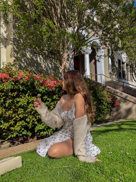 Girl with brown hair and a flower white dress and a cardigan, sitting on the grass in front of a flower bush Lilly + Core + Aesthetic, Alyssa Core Aesthetic, Ainsley Core, Alaina Core, Alina Core, Lilly Core, Alyssa Core, Spring Feed, Cottagecore Princess