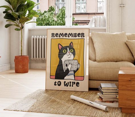 Brighten up your restroom with this adorable and witty poster, which showcases a tuxedo cat holding a roll of toilet paper and the friendly reminder "Remember To Wipe." This delightful print is perfect for adding a splash of charm and humor to any bathroom setting, ensuring both hygiene and giggles. ✅ ABOUT ✔️ Paper options - fine art and matte. 👉 Premium Fine Art Paper (240gsm). ✔️ NB! For indoor use only ⚠️ FRAME IS NOT INCLUDED ✅ SIZES Sizes in inches = 24 x 36, 20 x 30, 18 x 24, 16 x 20, 12 Behind The Toilet Art, Over Toilet Art, Retro Bathroom Wall Art, Cute Bathroom Art, Bathroom Frames Decor Wall Art, Bathroom Prints Art, Posters For Bathroom, Cat On Toilet, Powder Room Art