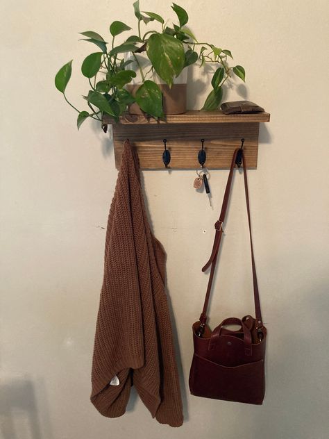 Tired of cluttered entryways and messy mudrooms? This handmade wooden coat rack organizes it all - outerwear, bags, hats, scarves and more! Custom length with sturdy hooks hold multiple coats, jackets, purses and hats. Spacious shelf neatly stores gloves, scarves, keys and other small accessories. Beautiful handcrafted solid wood design adds style to any space. With its clean lines and rich wood grain, this functional coat rack is perfect for entryways, mudrooms, dorm rooms and bedrooms. The hoo Entryway Coat Rack With Shelf, Jacket Rack, Purse Wall, Shelf Entryway, Hat Organizer, Bathroom Towel Rack, Solid Wood Design, Organizer Bathroom, Coat Rack Shelf