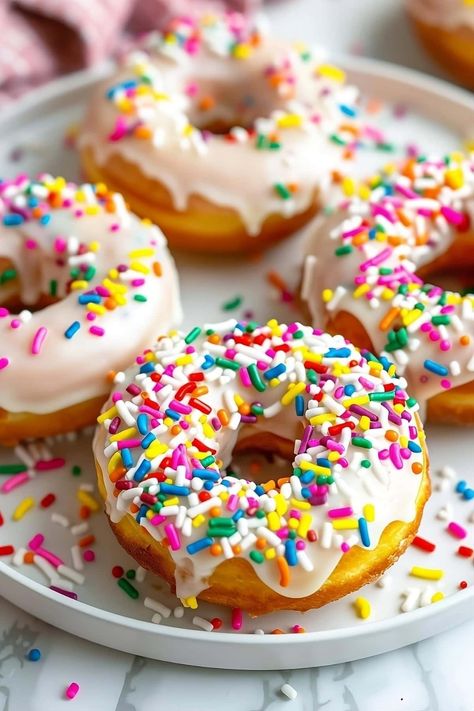 Skip the drive to your local donut shop and make these easy pancake mix donuts instead. They’re soft, sweet, and begging to be devoured. Pancake Doughnuts Recipe, Pancake Donuts Recipes Baked, Donuts With Pancake Batter, Pancake Donuts Baked, Muffin Mix Donuts Baked, Easy Baked Donuts With Donut Pan, Pancake Mix Donuts Recipes, Pancake Donuts Recipes, Bisquick Donut Recipe