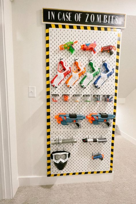 Are you looking for a fun and easy way to store and organize your son's Nerf guns? Our DIY Nerf Gun Wall is the perfect solution! Learn how to build a unique wall using easy-to-follow step-by-step instructions to create the ultimate boys room storage. Here you'll also find ideas to help organize Nerf guns and accessories. Please visit us for more boys room, storage, and organization ideas. Nerf Organization Ideas, Boys Room Storage, Nerf Storage, Boys Room Diy, Peg Wall, Boys Playroom, Playroom Organization, Shower Surround, Toy Rooms