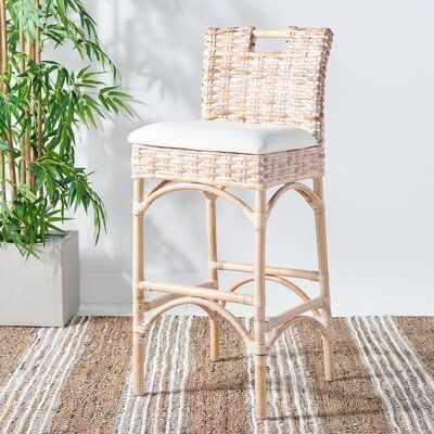 For elevated dining at a home bar or kitchen island, this stool adds a charming nautical touch to any home. The intricate, interwoven design of the seat and back sits on a gently curved, arched frame that adds to the natural aesthetics of this piece. Crafted from wicker rattan, this stool has a high back and a cushioned seat filled with foam and upholstered in a blend of polyester and cotton. With its array of finish options, this stool is a versatile addition to any living room, dining room, or Rattan Bar Stools, Tropical Interior, Coastal White, Wood Bar Stools, Bistro Chairs, Coastal Chic, Bar Furniture, White Wood, Home Collections