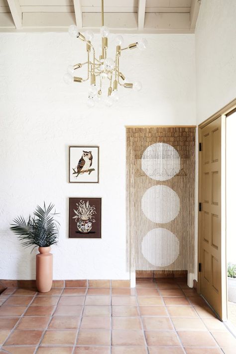 natural terracotta floor welcomes guests in this 70's airy scottsdale home. for natural terracotta options, check out our antique terracotta tiles at cletile.com #entryway #floor #tiles #terracotta Exit Room, Front Hall Closet, Urban Outfitters Curtains, Bamboo Beaded Curtains, Grey Backsplash, Bamboo Curtains, Terracotta Floor, Fireplace Hearth, Desert Homes