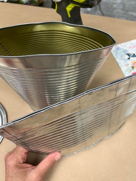 The first can that has the top and bottom off will be hammered flat on one end. You Smashed Can Wreath, Tin Can Wreath, Gallon Tin Can Crafts, Tin Coffee Can Ideas, Diy Tin Can Planter, Crafts Made From Tin Cans, Hanging Tin Can Planters, Tin Lids Crafts, Decoupage Smashed Tin Cans With Napkins