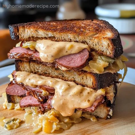 A savory twist on the classic Reuben sandwich, featuring kielbasa, sauerkraut, and Gouda cheese on pumpernickel bread. Saurkraut Recipes Sandwich, Kielbasa Sandwich, Kielbasa Sauerkraut, Gouda Cheese Recipes, Classic Reuben Sandwich, Sandwich Spreads, Reuben Sandwich Classic, Pumpernickel Bread, Cheese All